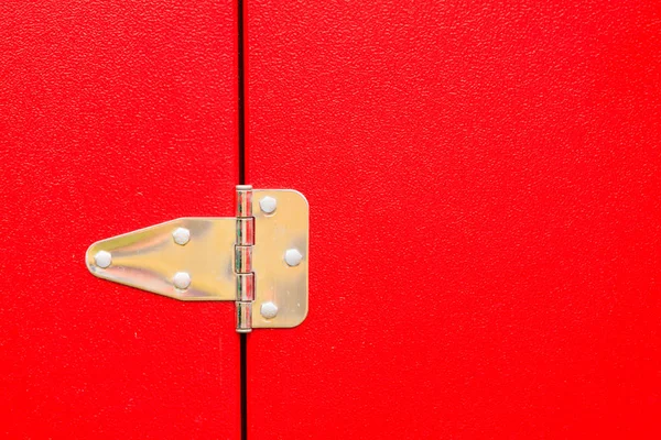 Metal steel hinge on red door — Stock Photo, Image