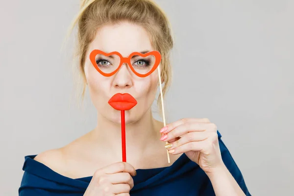 Woman holds carnival accessories on stick — Stock Photo, Image