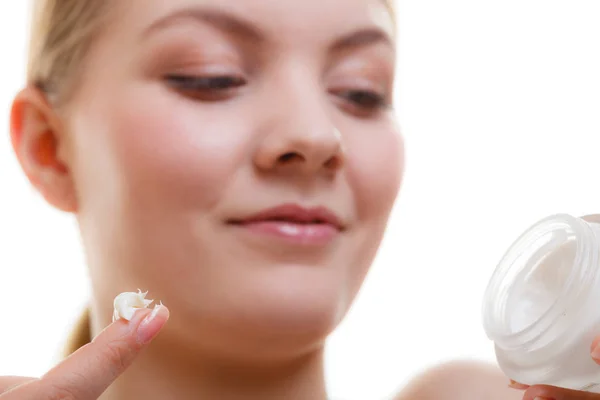 Woman applying face cream with her finger — Stock Photo, Image