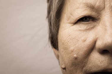 Elderly pensioner female half face portrait closeup clipart