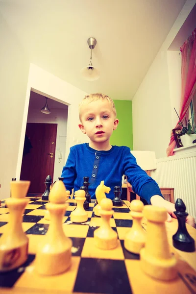 Young kid boy playing chess having fun — Stock Photo, Image