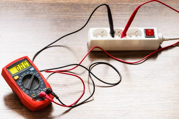 Measurement voltage in electrical socket with multimeter — Stock Photo, Image