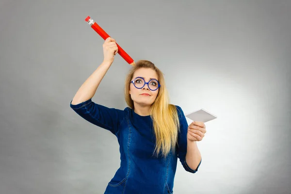 Femme confus tient grand papier de note de crayon dans la main — Photo