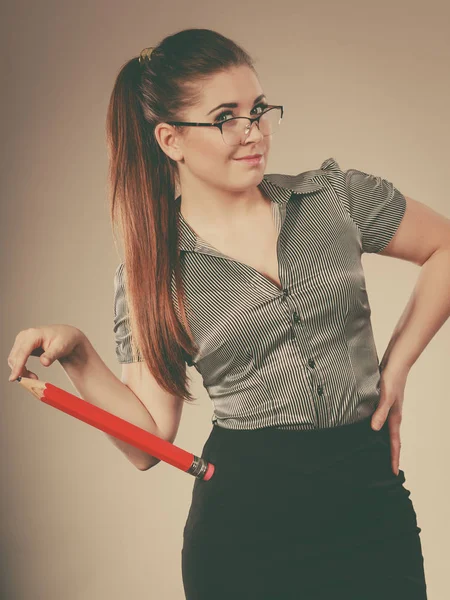 Teacher looking elegant woman holding big pencil — Stock Photo, Image