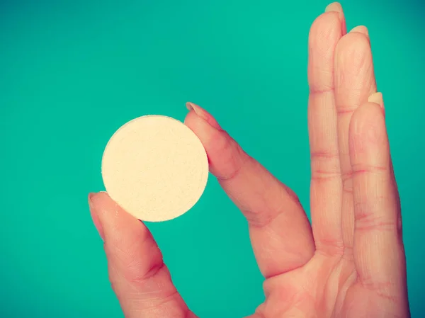 Woman hand holding big effervescent pill — Stock Photo, Image