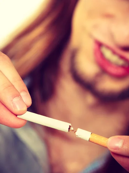 Young man is breaking a cigarette — Stock Photo, Image