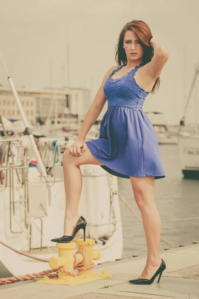 Dominant feminist woman wearing high heels in marina — Stock Photo, Image