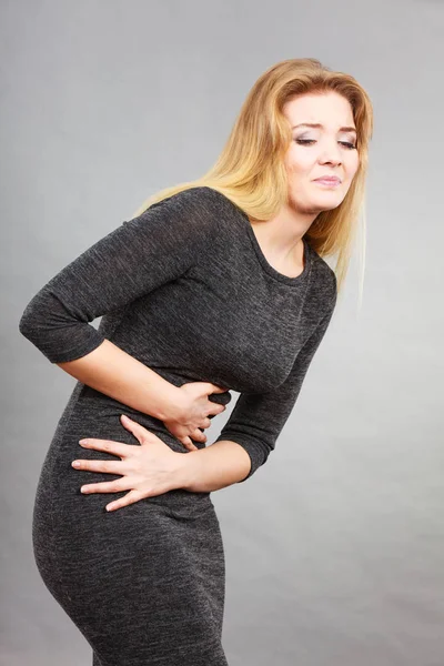 Woman feeling stomach cramps holding her belly — Stock Photo, Image
