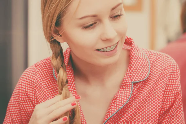 Woman doing braid on blonde hair — Stock Photo, Image