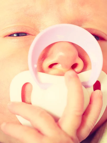 Крупный план новорожденного, лежащего с соском во рту — стоковое фото