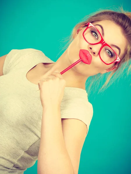 Happy woman holding fake lips on stick — Stock Photo, Image