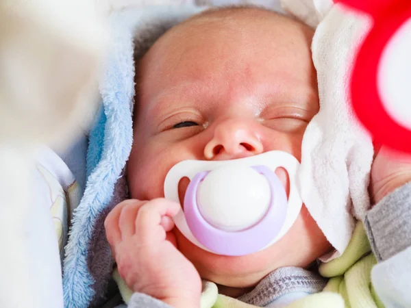 Closeup of little newborn sleeping with teat in mouth — Stock Photo, Image