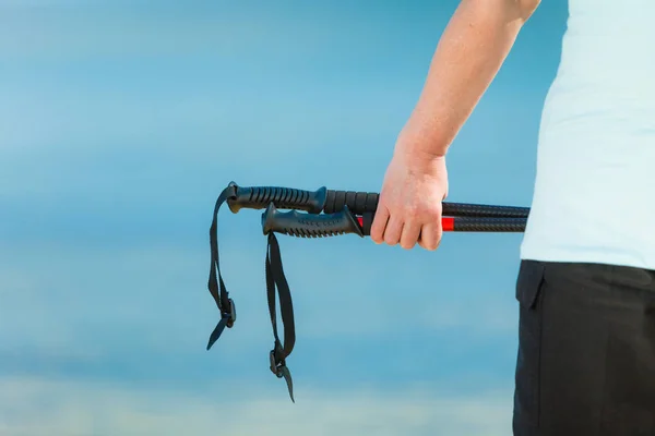 Hand holding hiking pole on nature background — Stock Photo, Image