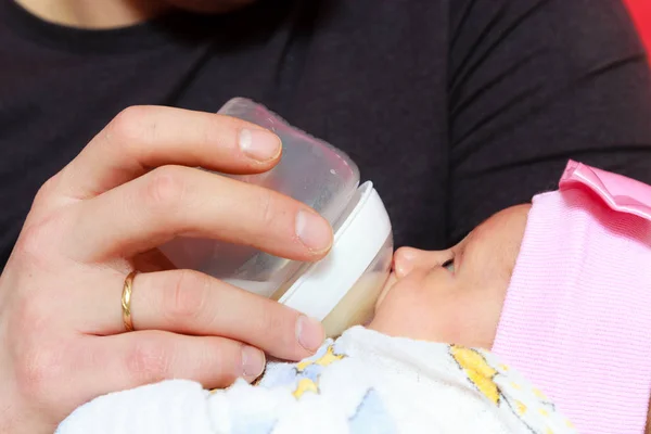 Little newborn baby lying, drinking from bottle — Stock Photo, Image