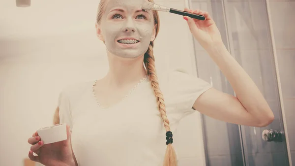 Woman with grey clay mud mask on her face — Stock Photo, Image