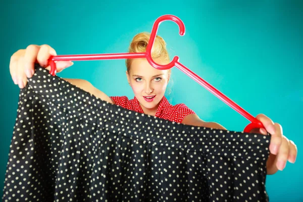 Retro vintage woman holding hanger with skirt — Stock Photo, Image