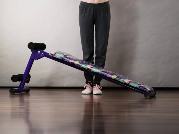 Woman legs behind sit ups bench — Stock Photo, Image