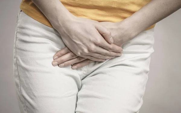 Woman with hands holding her crotch — Stock Image Woman with hands holding her crotch Stock Photo