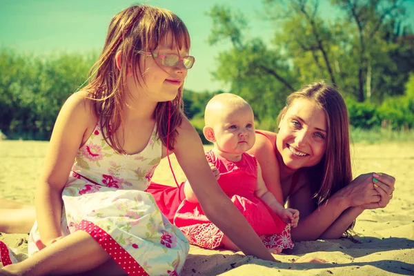 Woman spending time with kids on beach — Stock Photo, Image