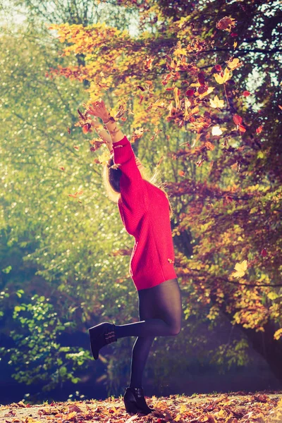 Verspielte Frau im Freien, die mit Blättern spielt. — Stockfoto