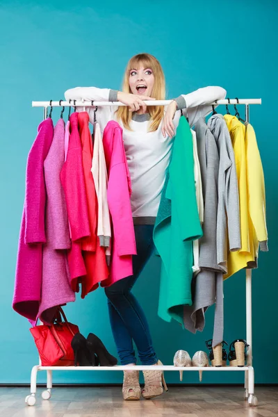 Woman choosing clothes to wear in mall or wardrobe — Stock Photo, Image