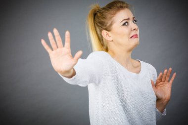 Scared woman gesturing stop gesture with hands clipart
