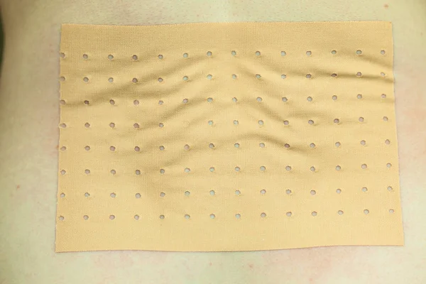 Heating pad, plaster bandage on back — Stock Photo, Image
