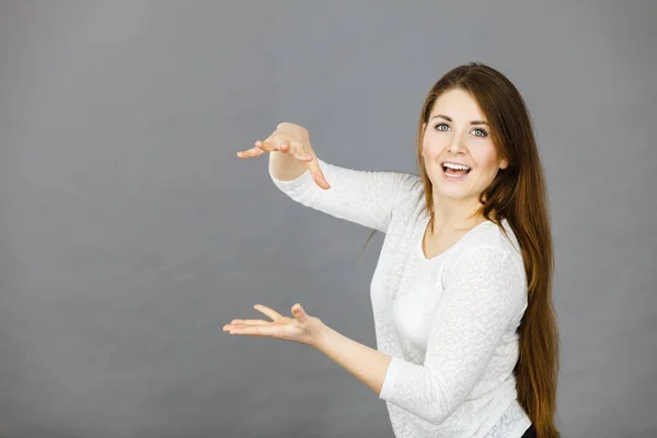 Happy woman presenting copyspace with hands — Stock Photo, Image