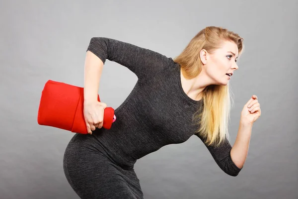 Vrouw loopt met warm waterfles, remedie tegen pijn — Stockfoto