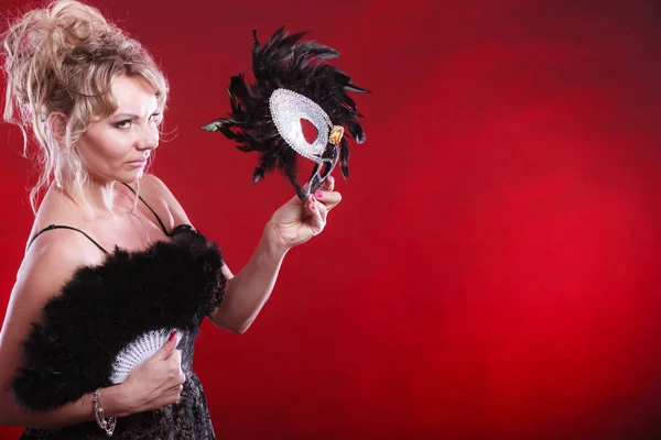 Woman holding carnival mask feather fan in hand — Stock Photo, Image