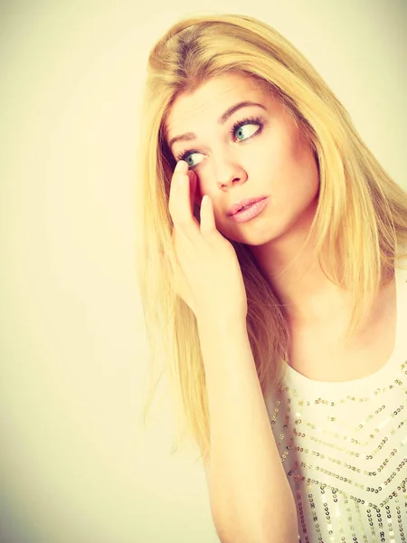 Attractive blonde woman having something in eye — Stock Photo, Image