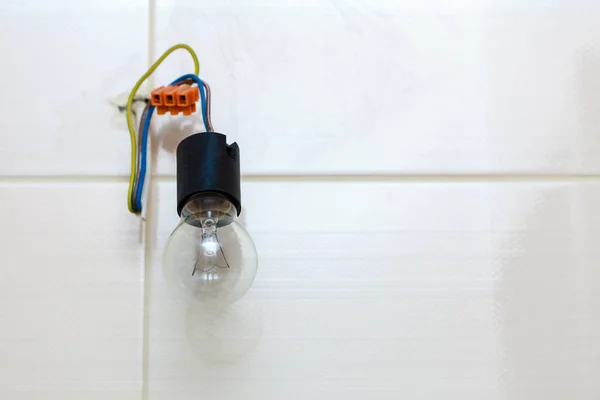 Small bulb hanging on wires — Stock Photo, Image