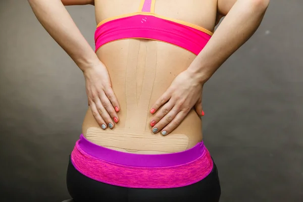 Woman with medical kinesio taping on back — Stock Photo, Image