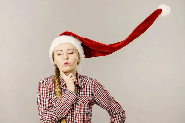 Funny girl wearing blowing santa claus hat — Stock Photo, Image