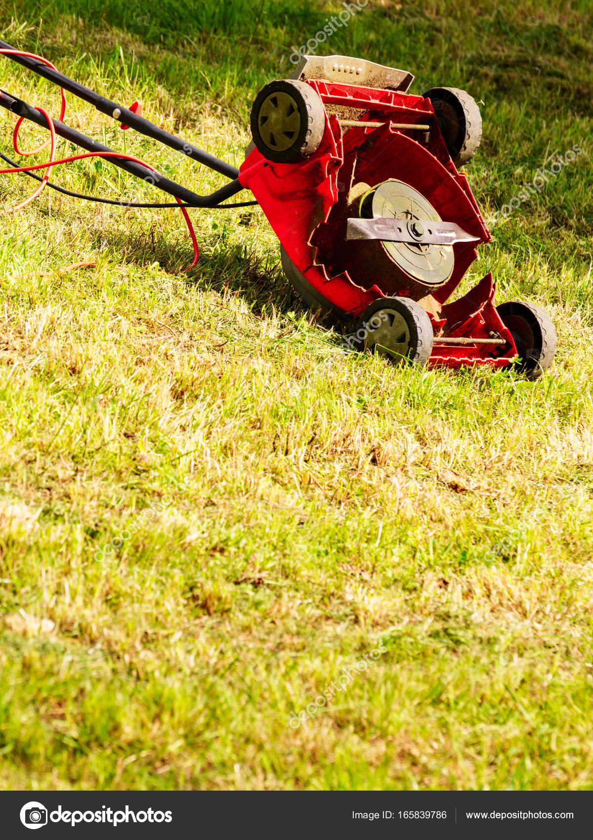 Broken old lawnmower in backyard grass Stock Photo by ©Voyagerix 165839786