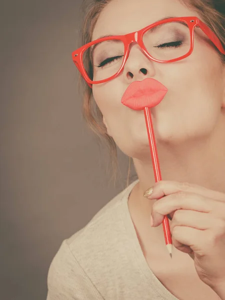 Happy woman holding fake lips on stick — Stock Photo, Image