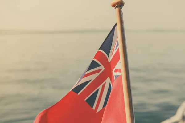 Uk red ensign the british maritime flag flown from yacht — Stock Photo, Image