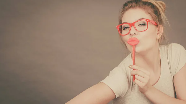 Щаслива жінка тримає підроблені губи на паличці — стокове фото