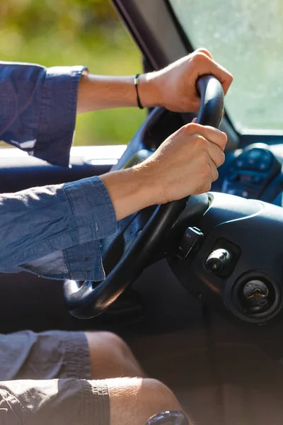 Man hands on steering wheel, driving car — Stock Photo, Image