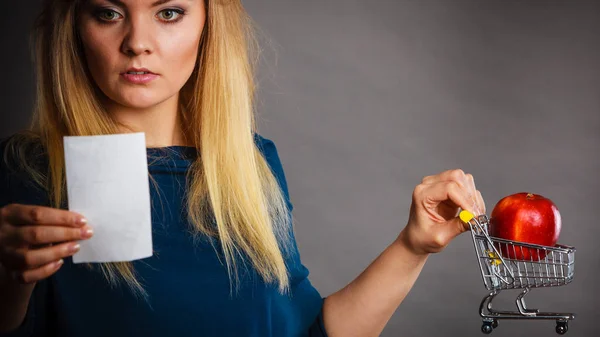 Orolig kvinna som håller varukorg med frukter — Stockfoto