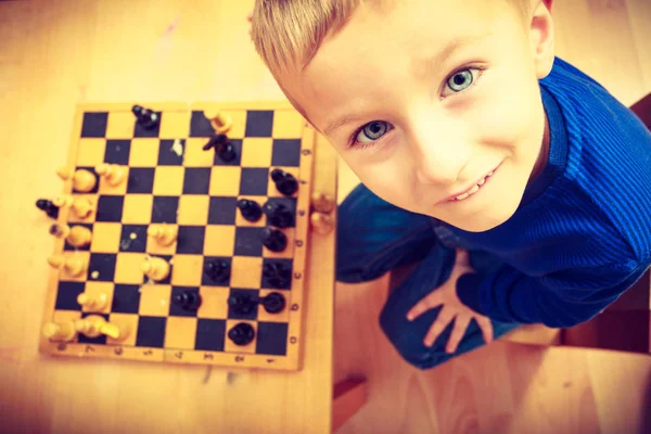 Young kid boy playing chess having fun — Stock Photo, Image