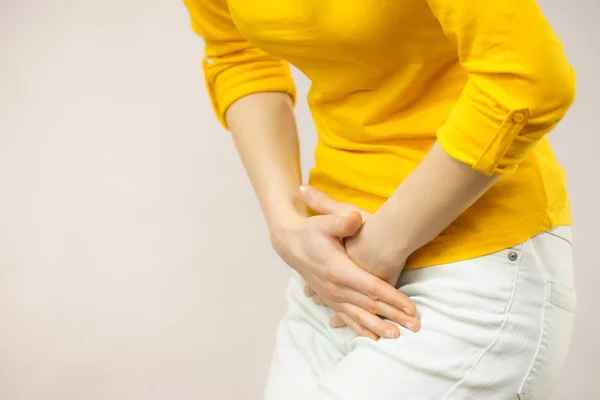 Woman with hands holding her crotch — Stock Image Woman with hands holding her crotch Stock Picture