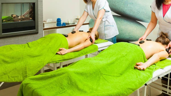 Massage with hot rocks stones in beautician — Stock Photo, Image