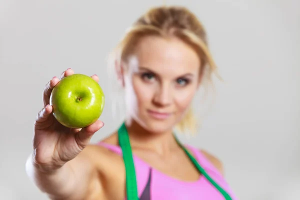 Woman fit girl with measure tape and apple fruit — Stock Photo, Image