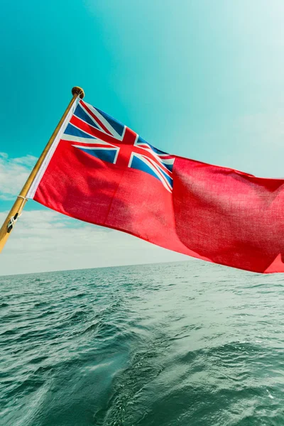 Uk red ensign the british maritime flag flown from yacht — Stock Photo, Image