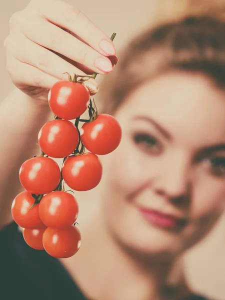 Woman holding fresh cherry tomatoes — Stock Photo, Image