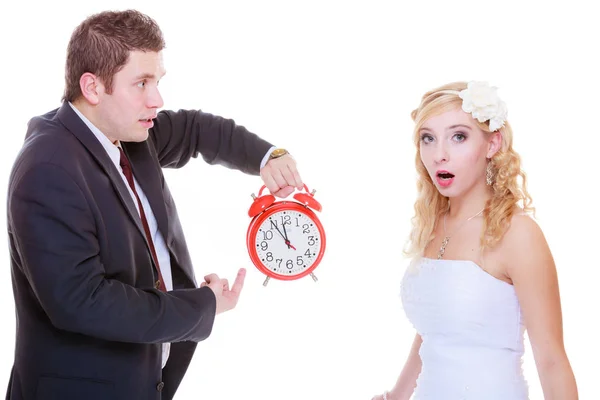 Groom holding big red clock yelling and bride — Stock Photo, Image