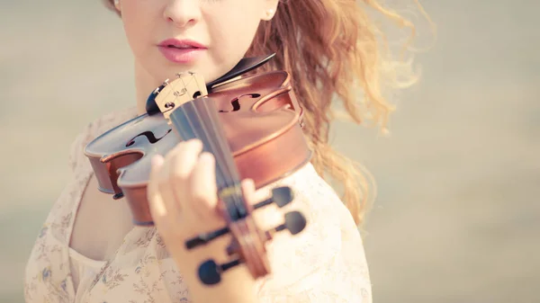 Kvinna som spelar fiol på violin nära stranden — Stockfoto