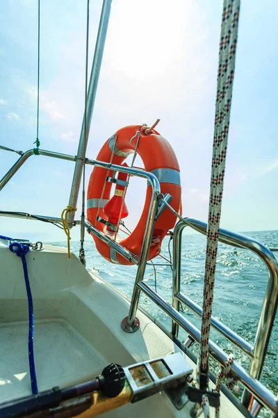 Rescue red lifebuoy life preserver saver ring on sailboat