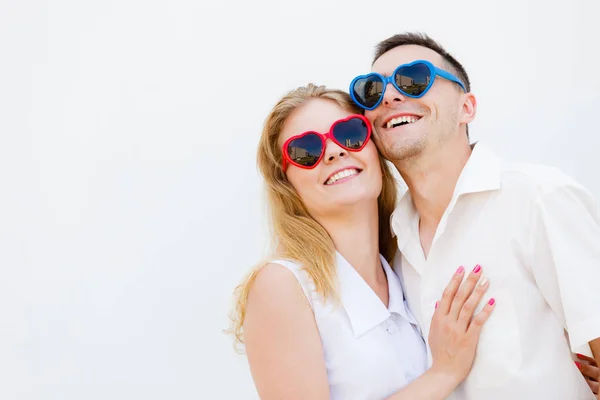 Man and woman wearing heart shape sunglasses — Stock Photo, Image